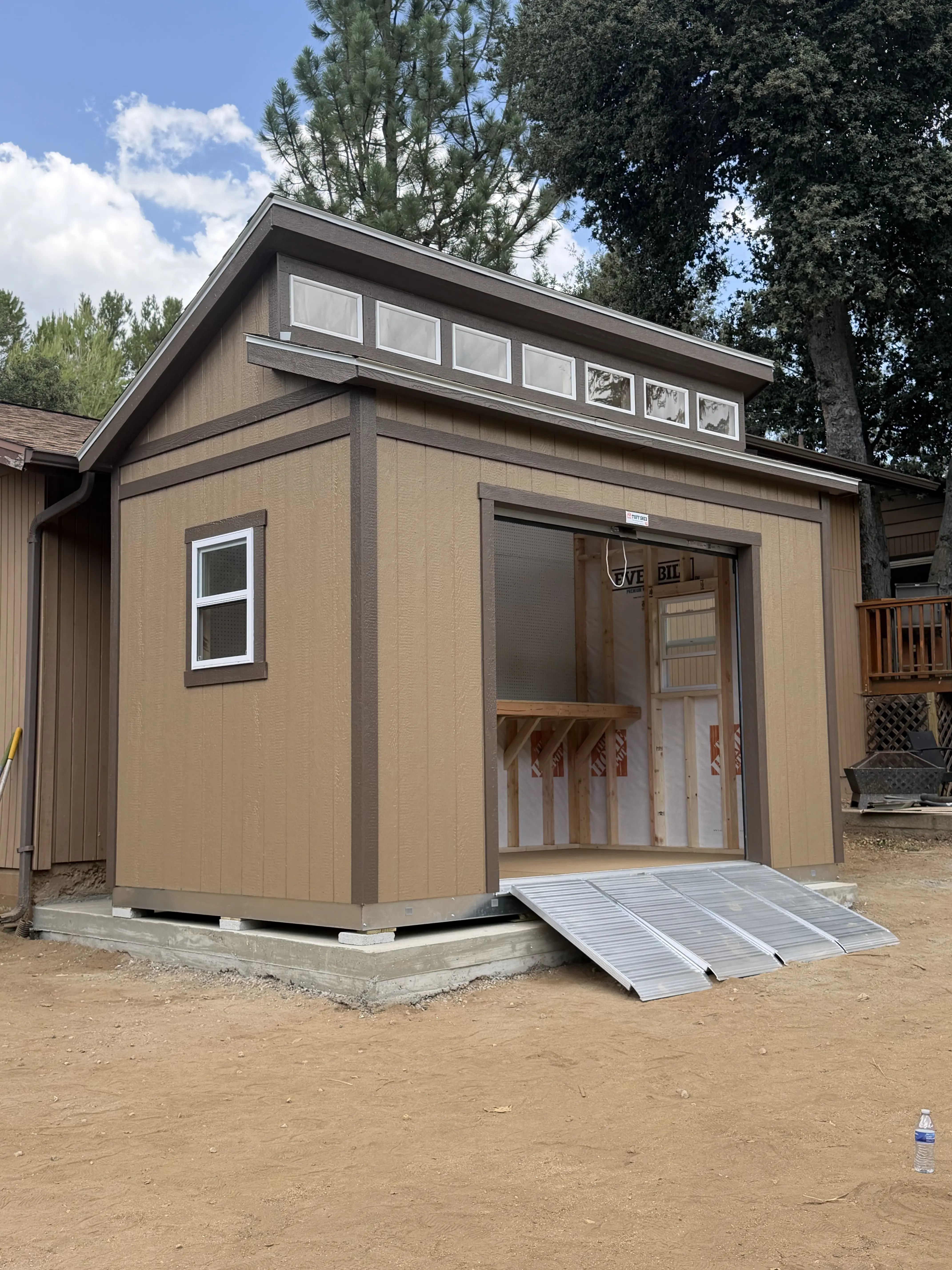 A shed with upper windows and an access ramp